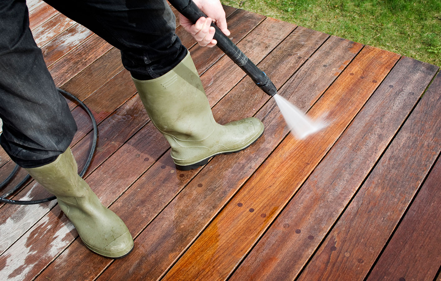 Holzterrasse wird mit Wasser gereinigt